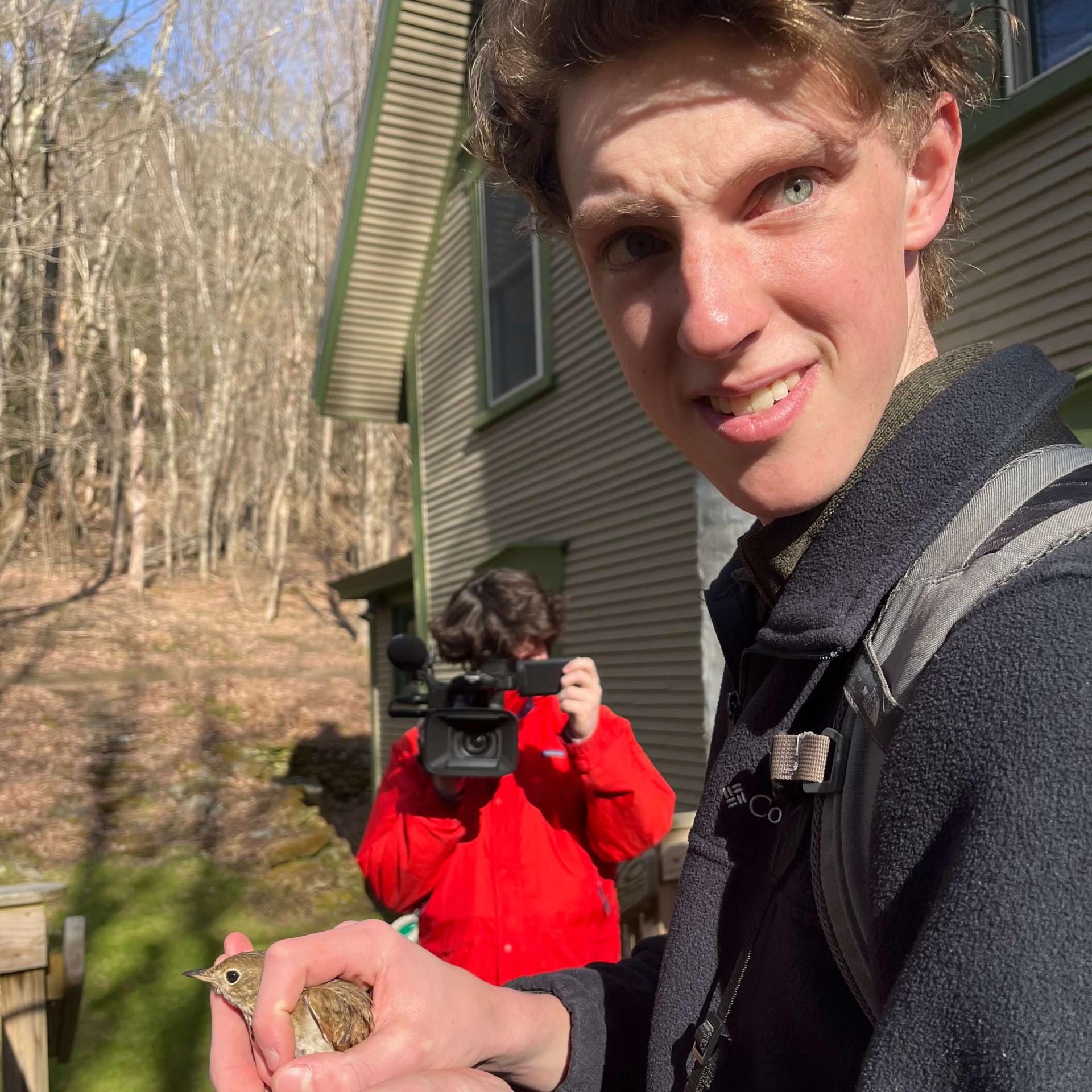 Spencer holding a hermit thrush.