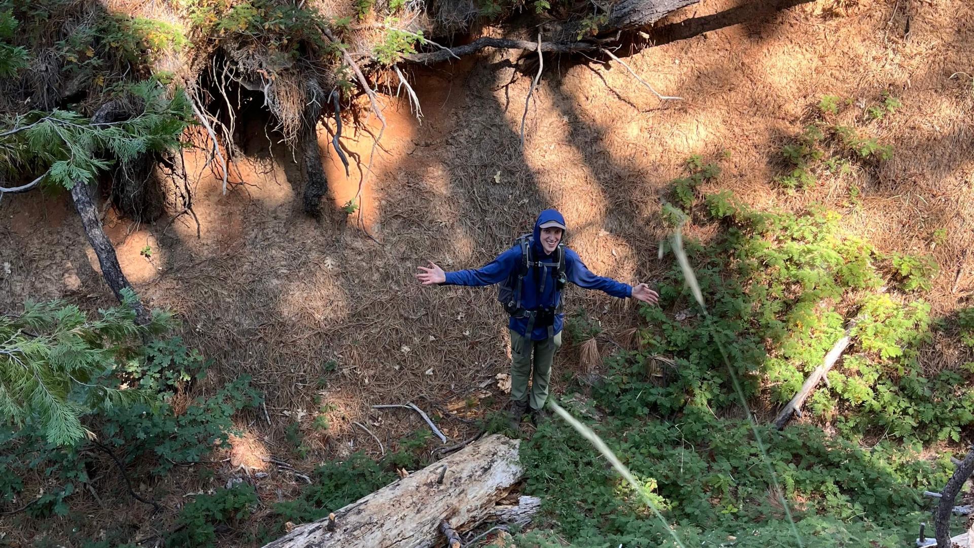Spencer standing in a ditch.