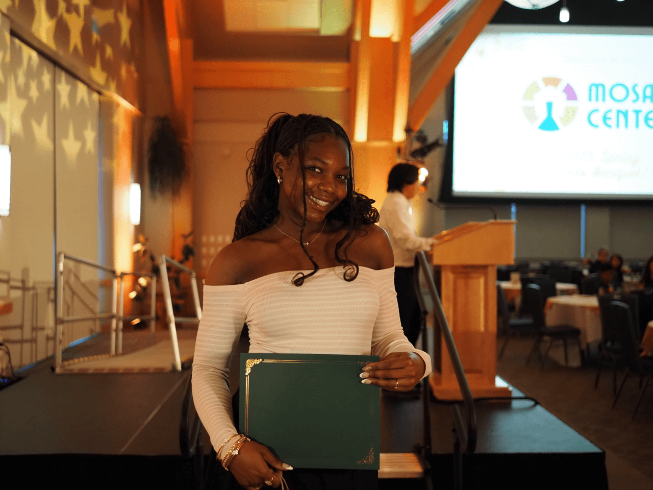 Student holding up an award