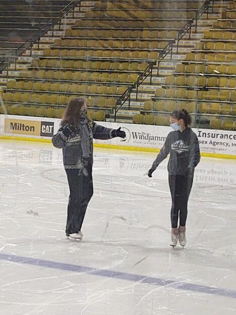 Pat Stokowski instructing a student on the ice