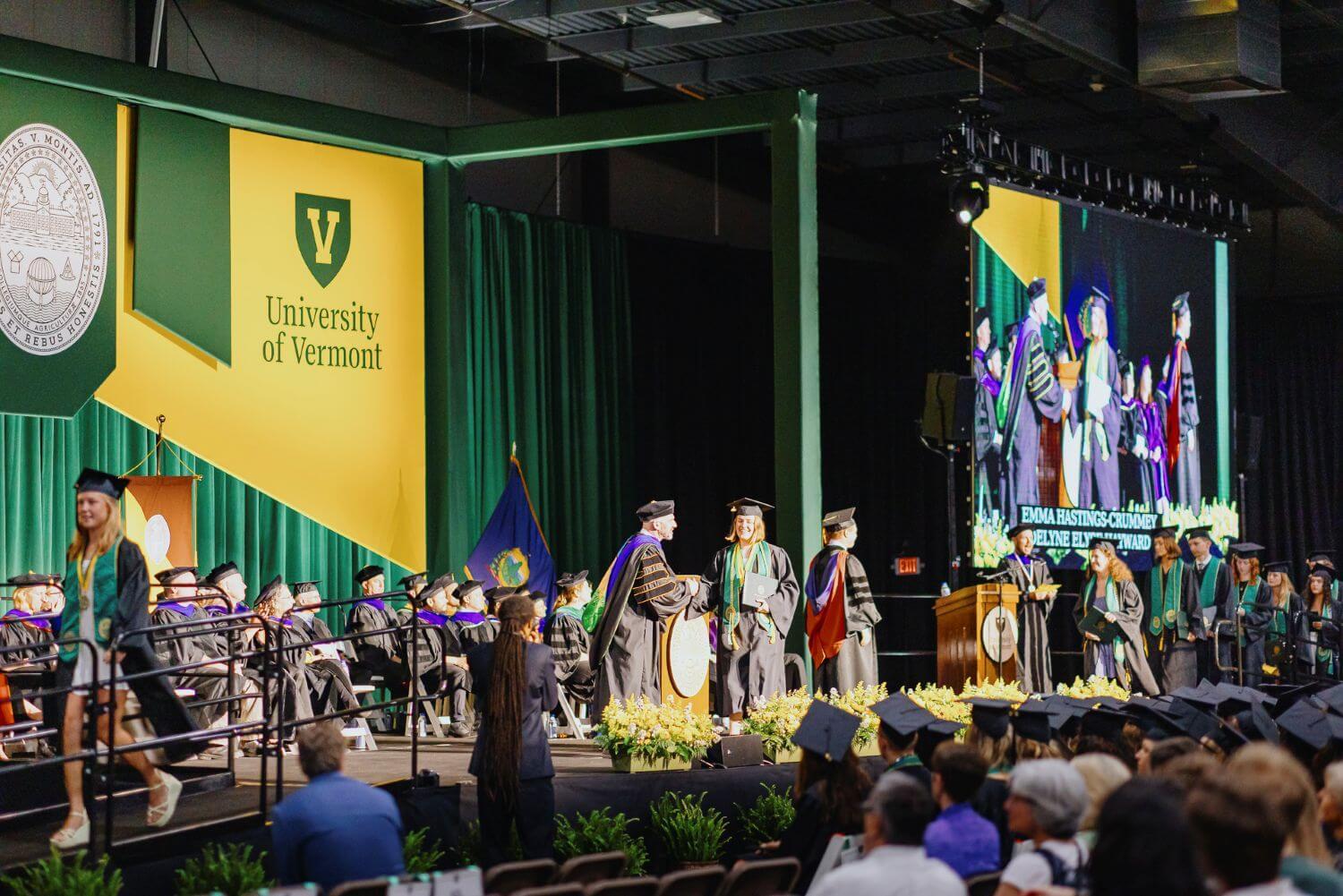 Students cross the RSENR commencement stage with diplomas in hand