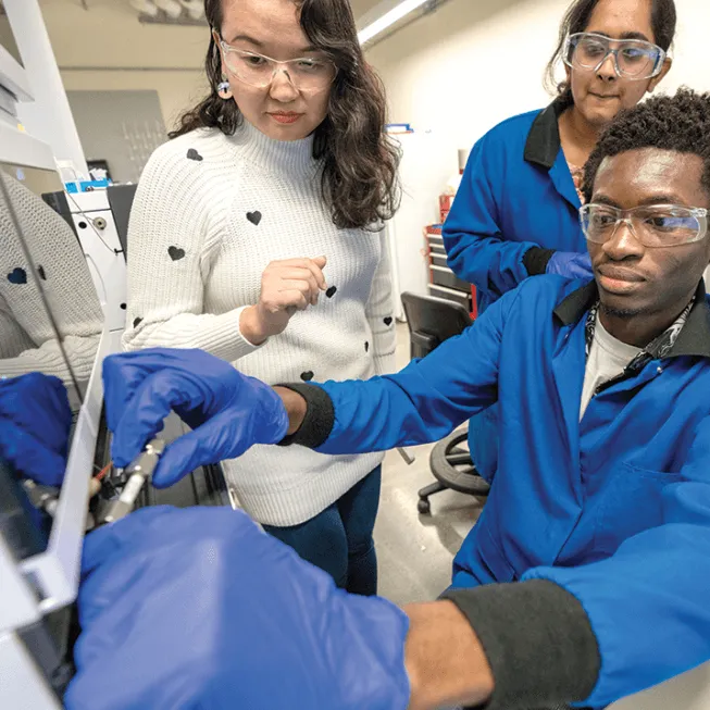 Three people conducting a test in a lab