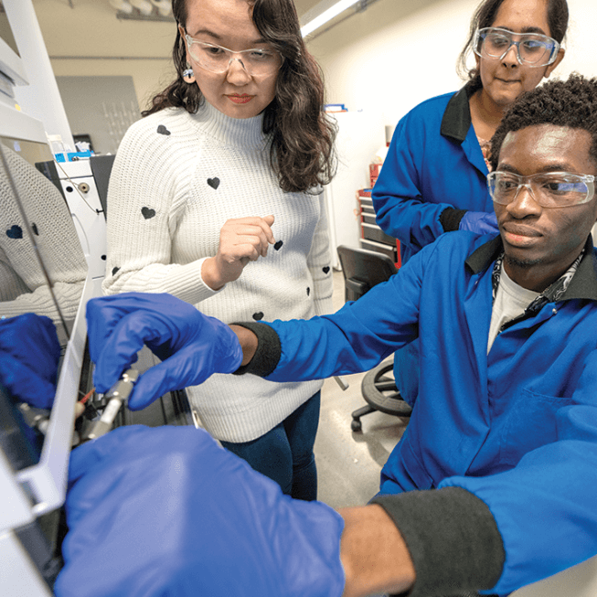 Three people conducting a test in a lab