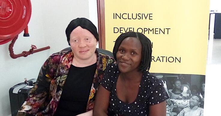 Woman smiling with a child with a disability.