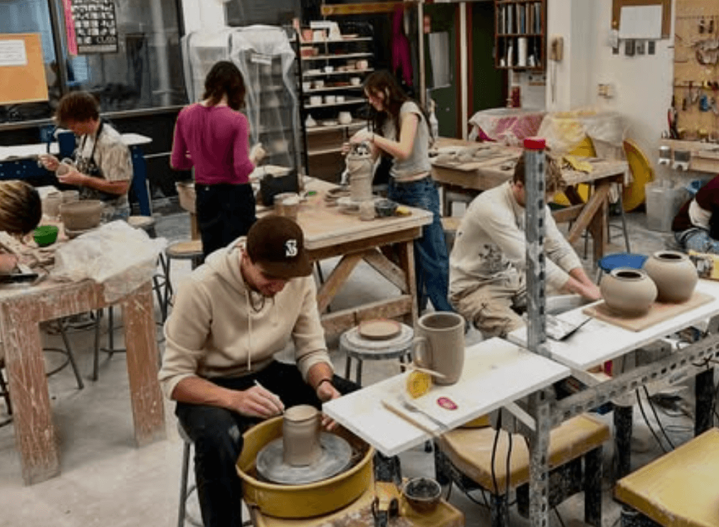Students working on pottery projects in the ceramics studio