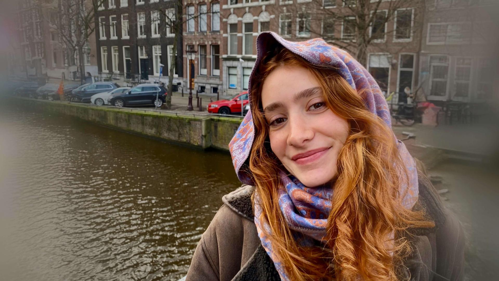 Chloe Martelon standing on a bridge in Amsterdam.