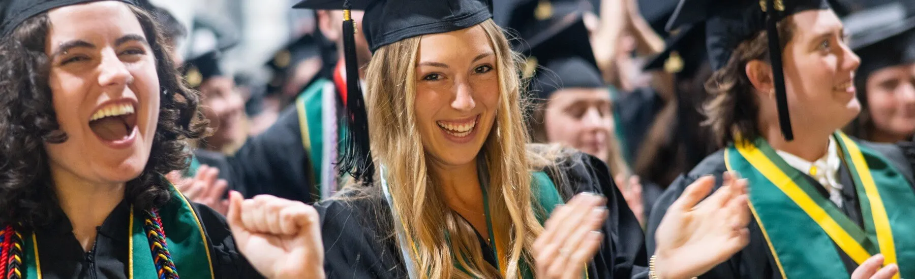 CNHS graduates clapping at commencement