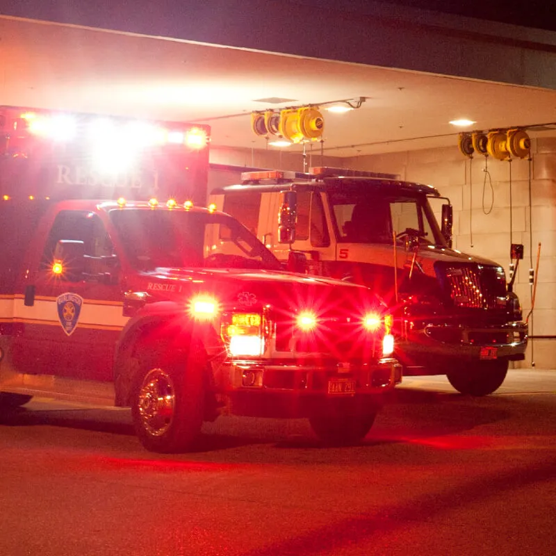 Ambulances outside emergency room at night