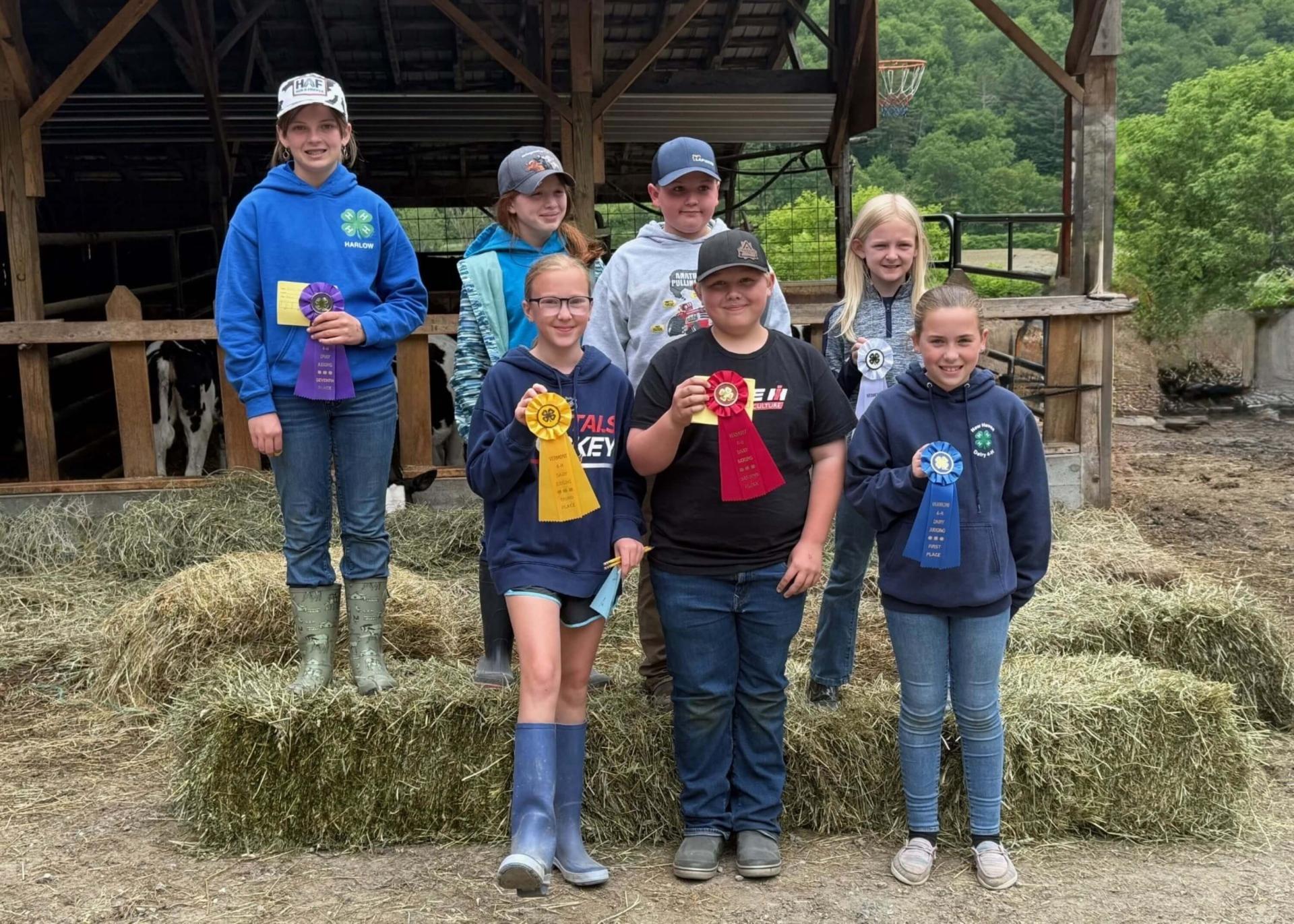 a group of 4-h'ers holding ribbons