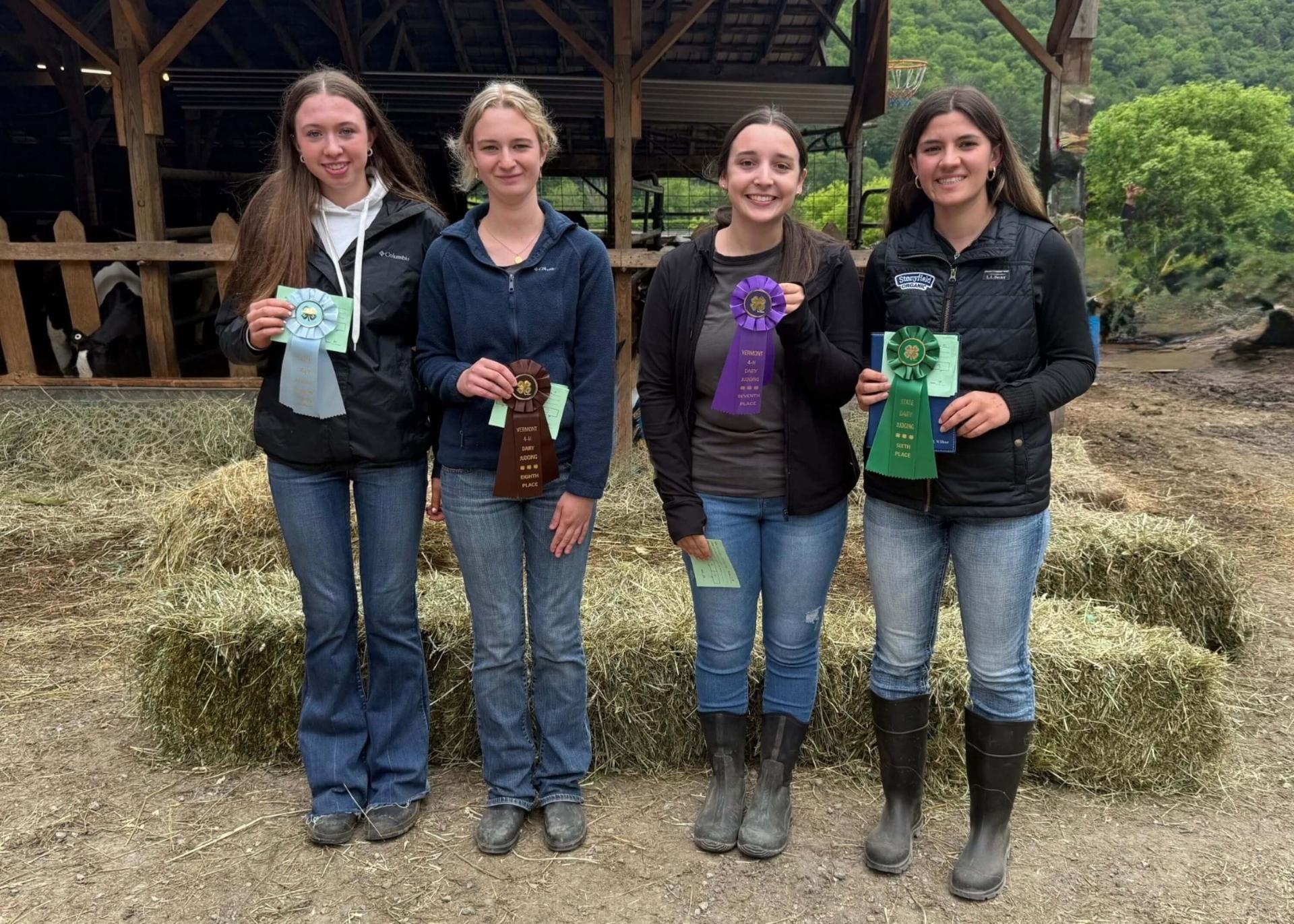 4 4-H'ers holding ribbons