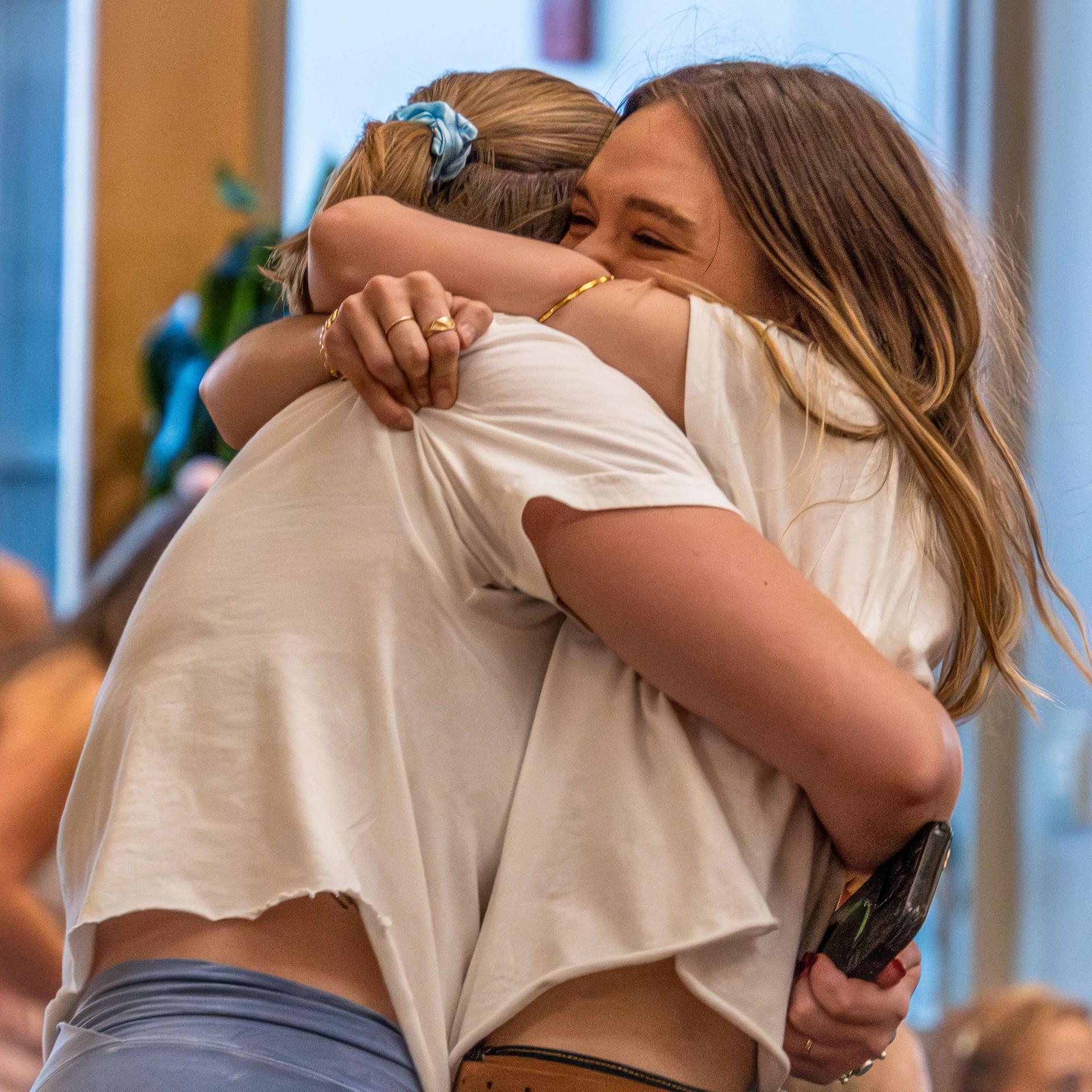 Two sorority member embrace at formal recruitment 