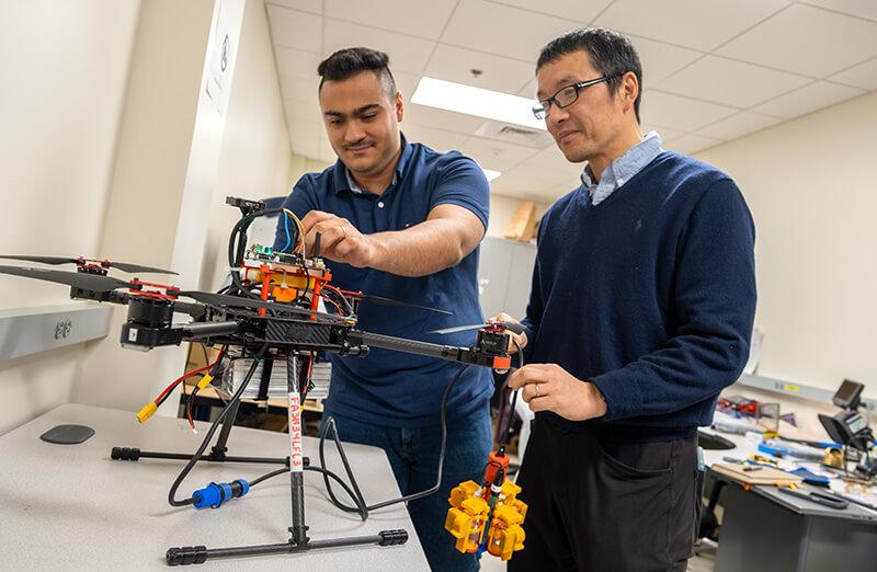Graduate student works alongside professor Tian Zia in his lab.