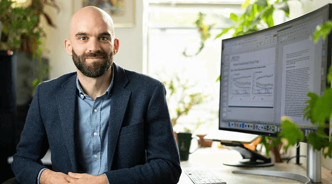 a man near a computer in an office