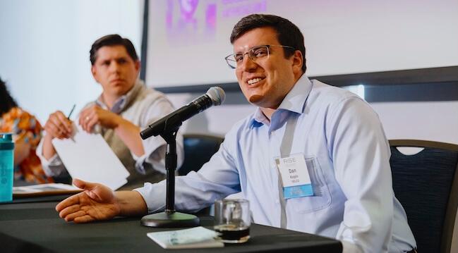a person speaking at a panle discussion