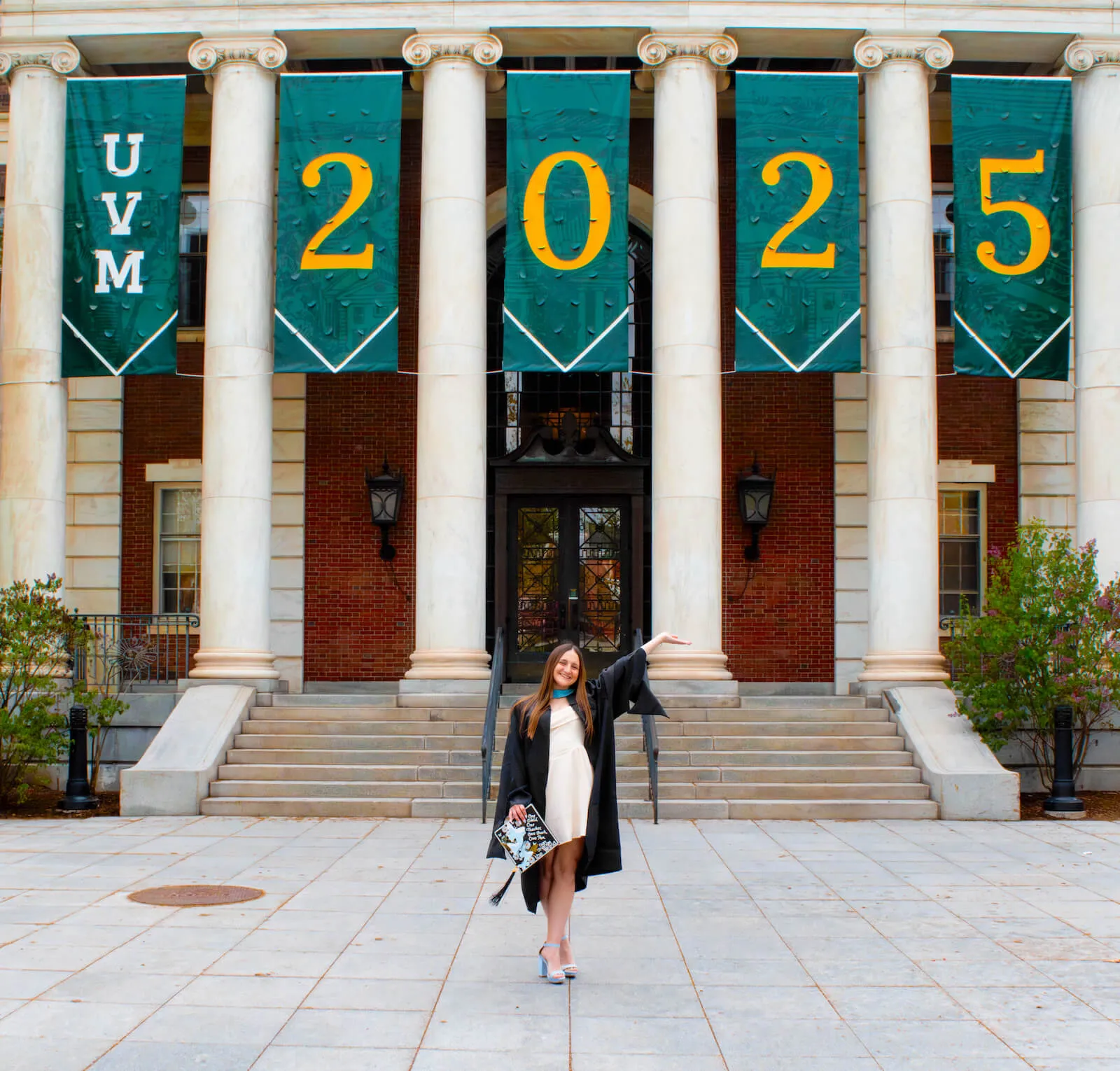 Maggie Sorrentino in front of the UVM Class of 2025 banner in front of Waterman Building.