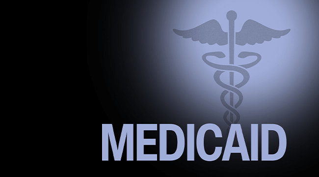 a dark graphic of the word Medicaid and the caduceus symbol