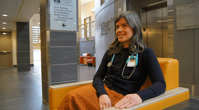 a doctor sitting in a chair in a hallway