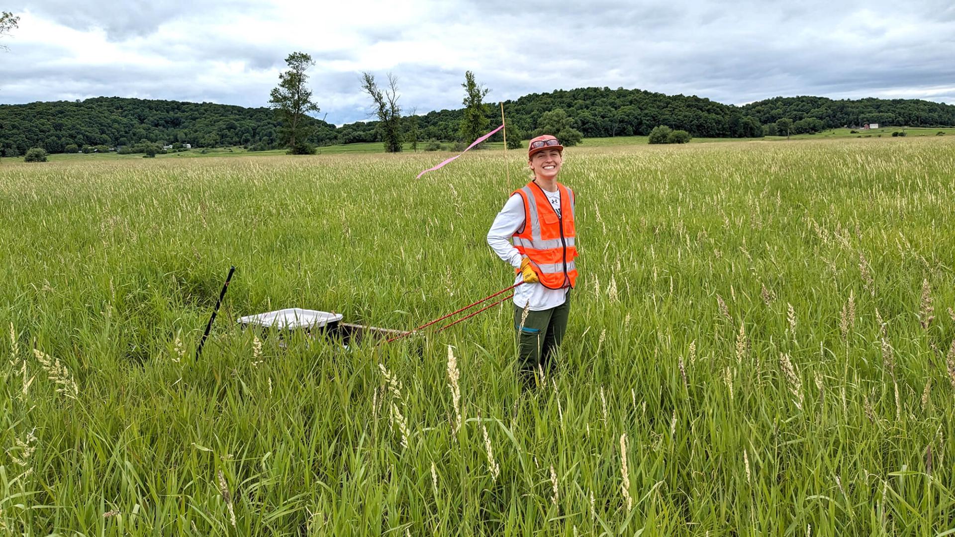 Environmental Engineering Student Victoria Horton ’25 collects vegetation samples in the Lake Champlain watershed. 