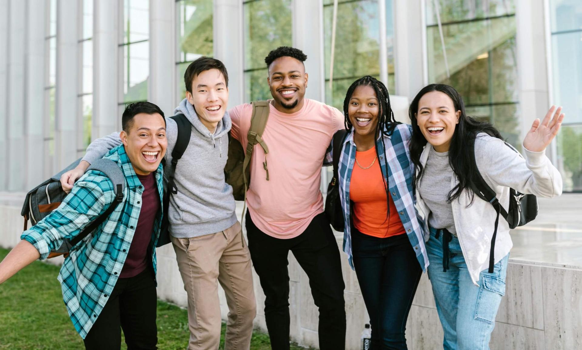 5 students arm in arm dressed casually