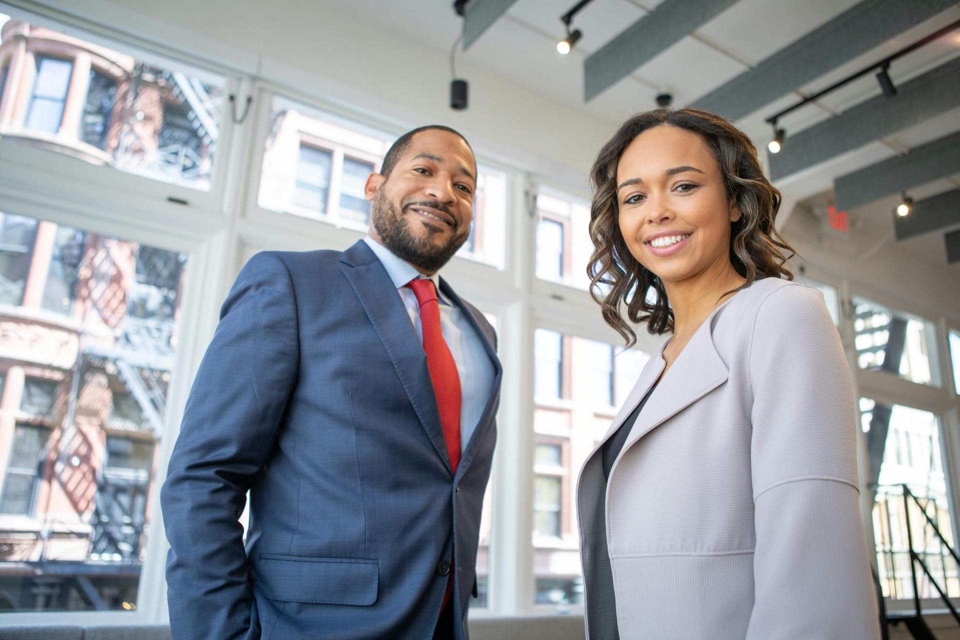 two business people smiling in an office