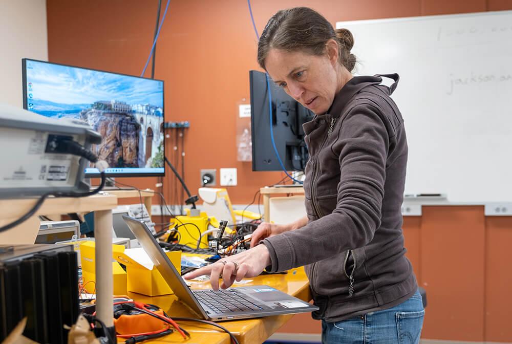Montpelier High School science and math teacher Anne Watson assembles her final project—a mobile robot featuring several wireless sensors.