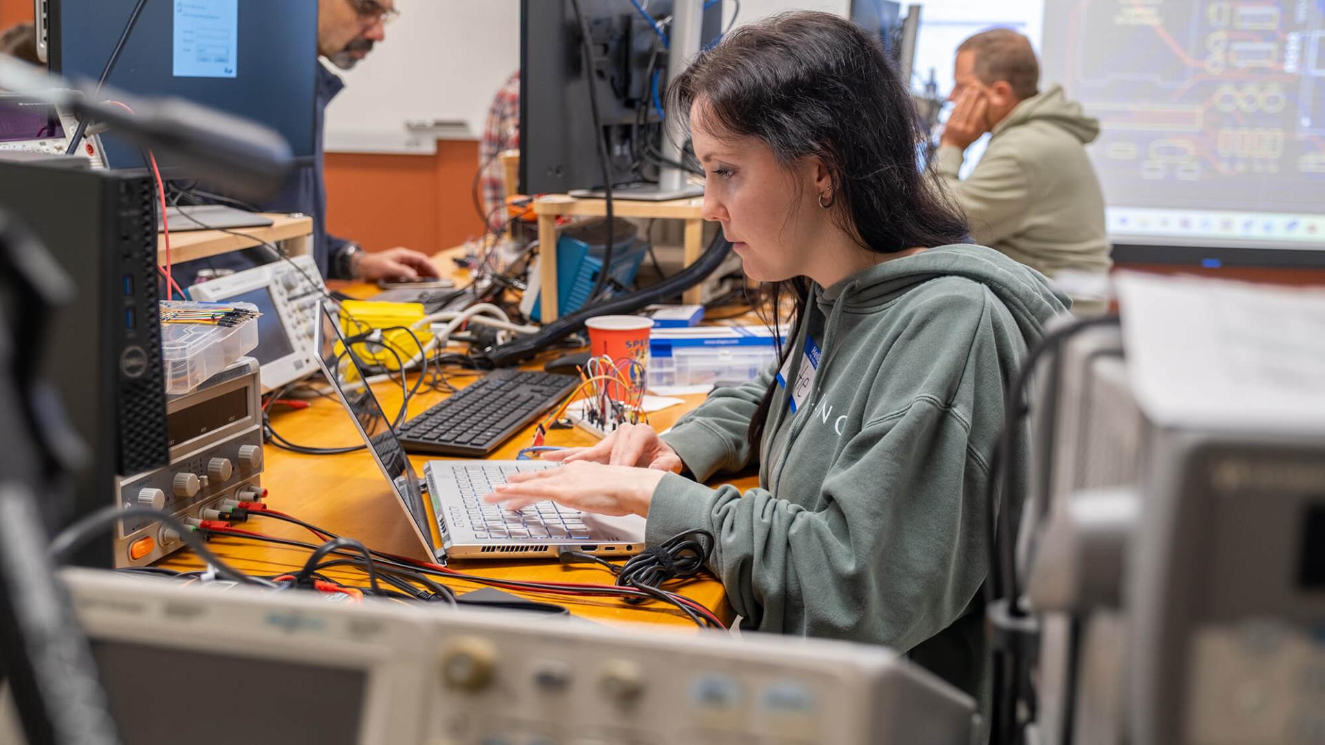 Computer Systems Technology Instructor Katie Dowman from the Essex Center for Technology assembles her mobile robot during the SPARK retreat.