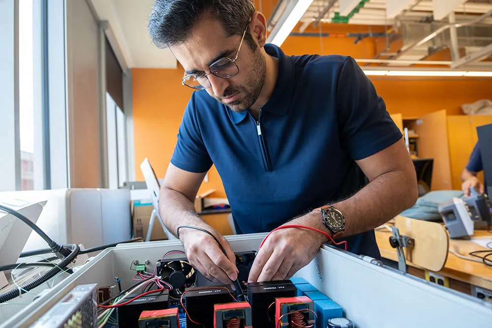 Graduate Research Assistant Arash Omidi examines electrical inverters used in the ATL