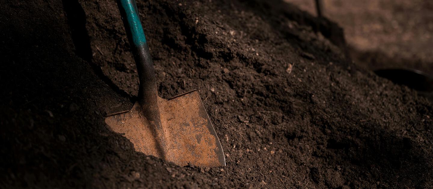 pile of composted dirt with a shovel in it