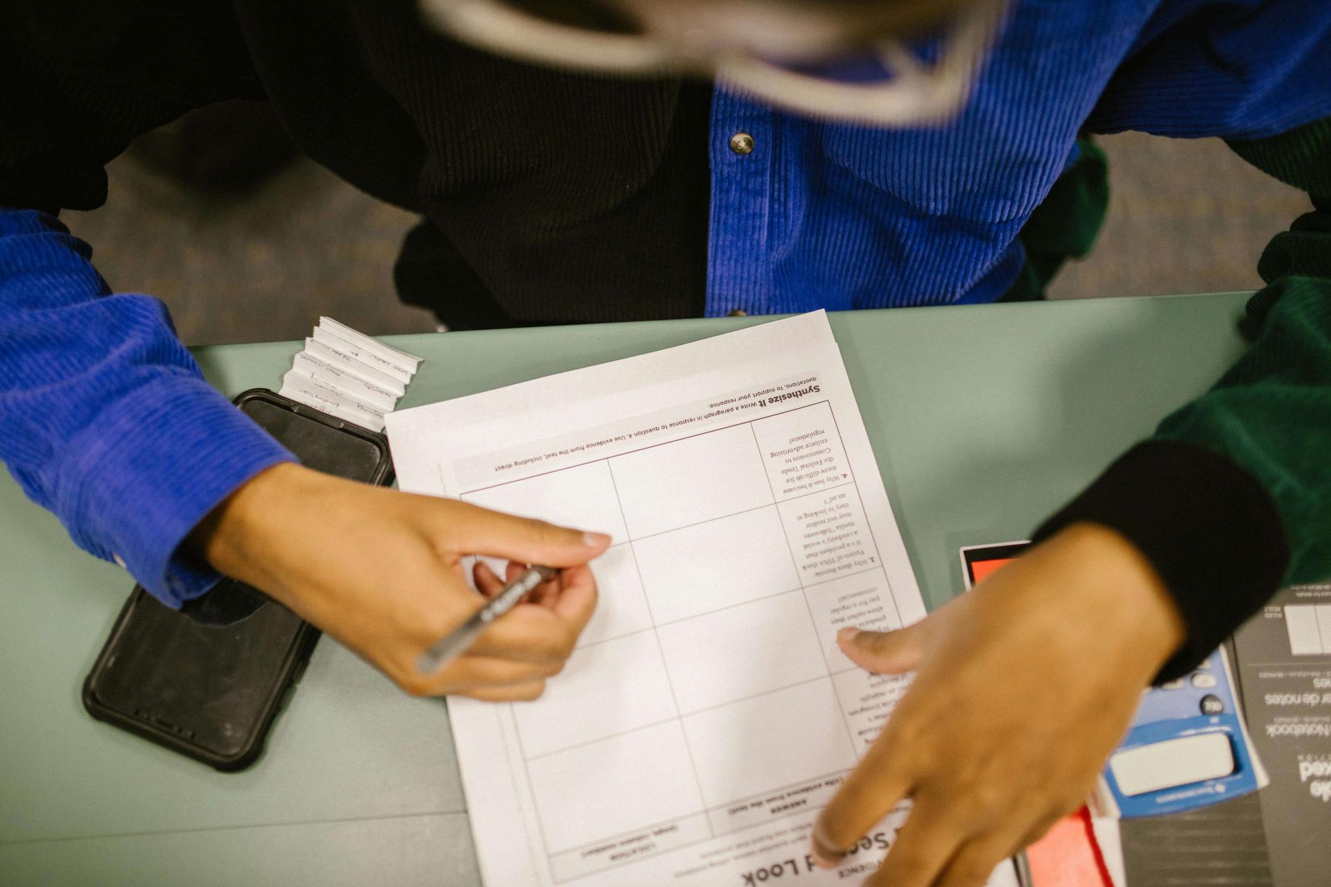 Overhead shot of a student taking an exam on paper