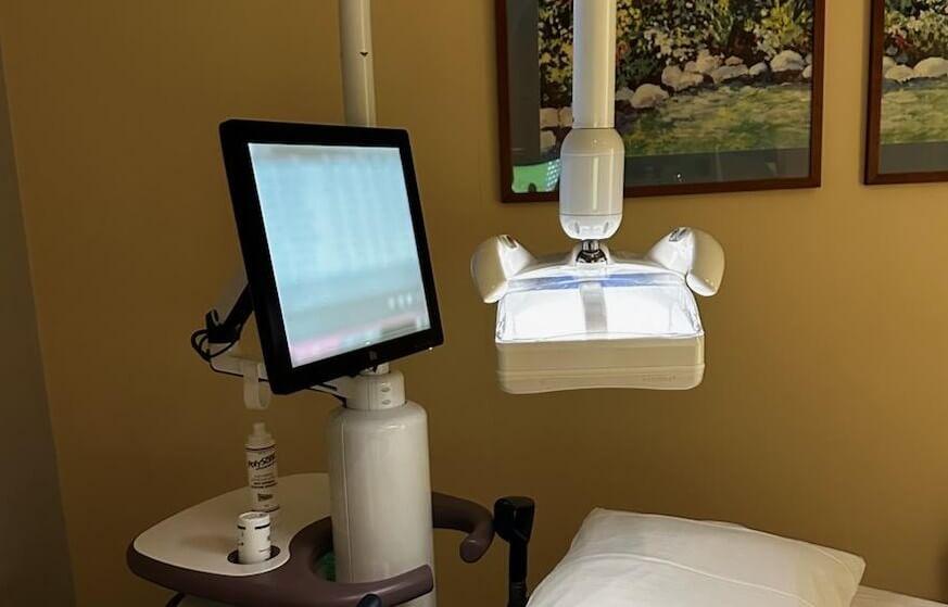 Automated breast ultrasound machine at the head of a hospital bed.