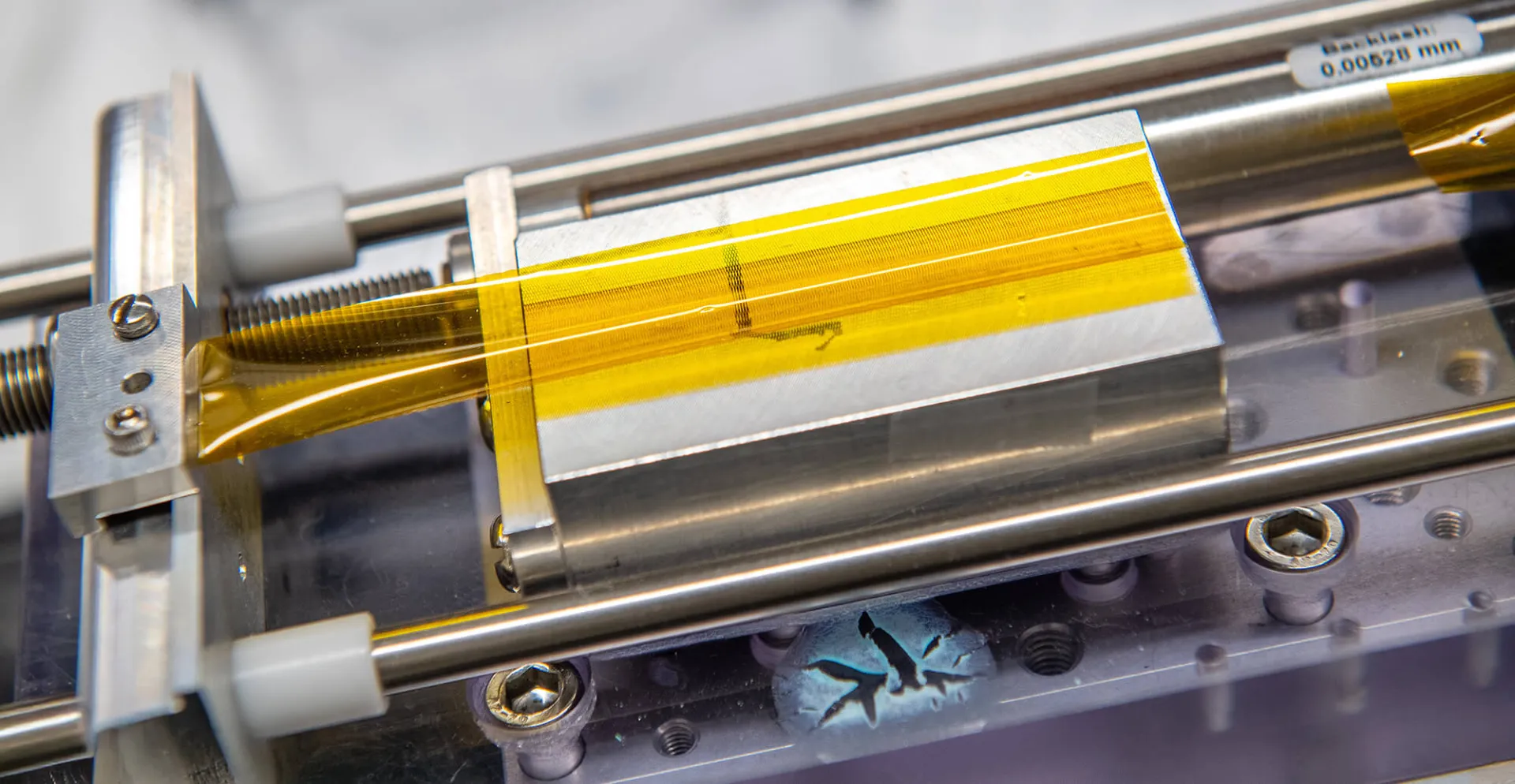 Image of a piece of thin film being tested in a materials lab