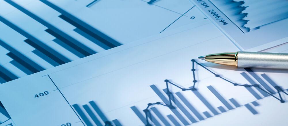 Image of data charts and a pen