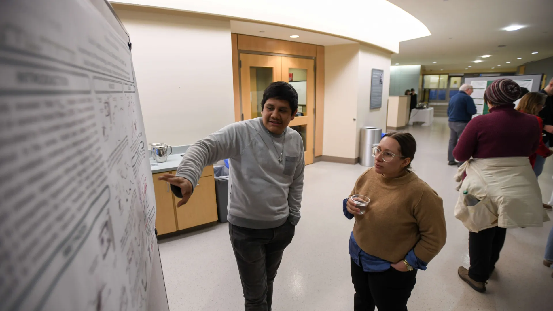 two people looking at poster