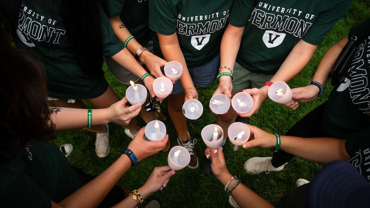 new UVM students hold candles at Convocation