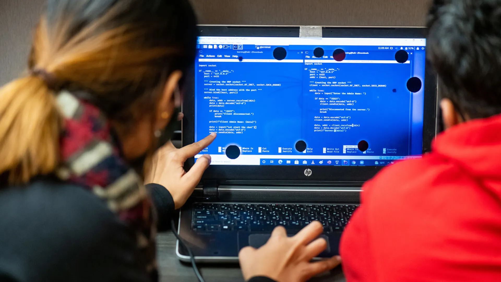 A professor and student work together on a coding assignment