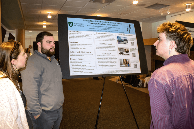 Students share information about their project for the Center of Community News 