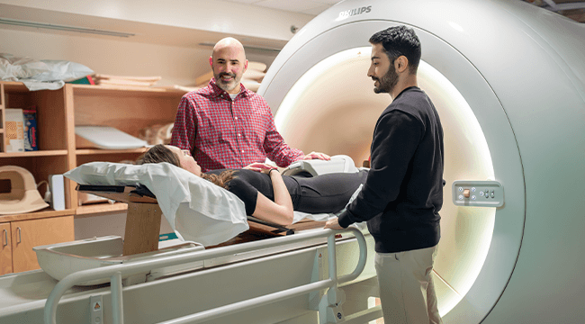 3 people with an MRI machine