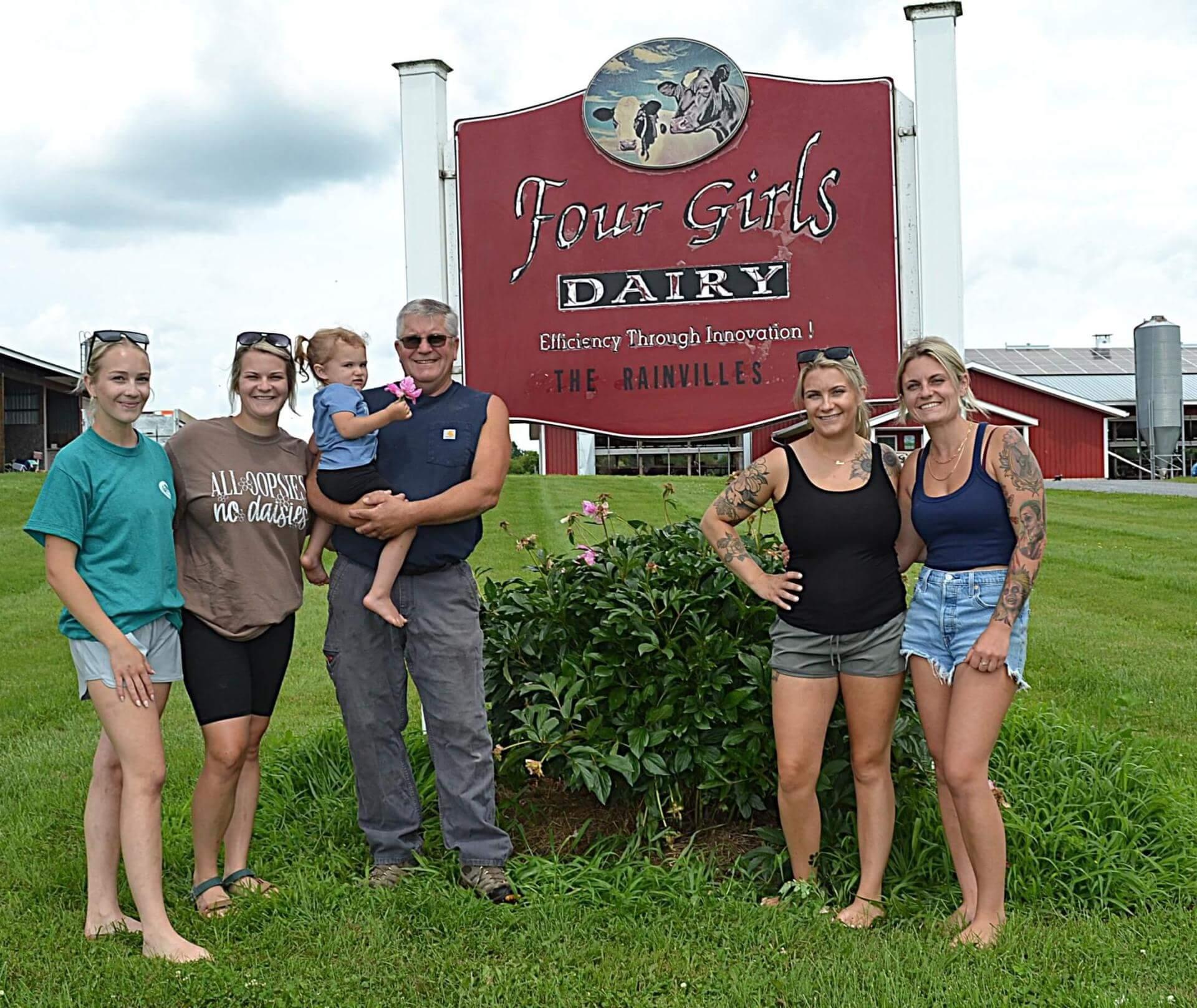 family standing in front of sign