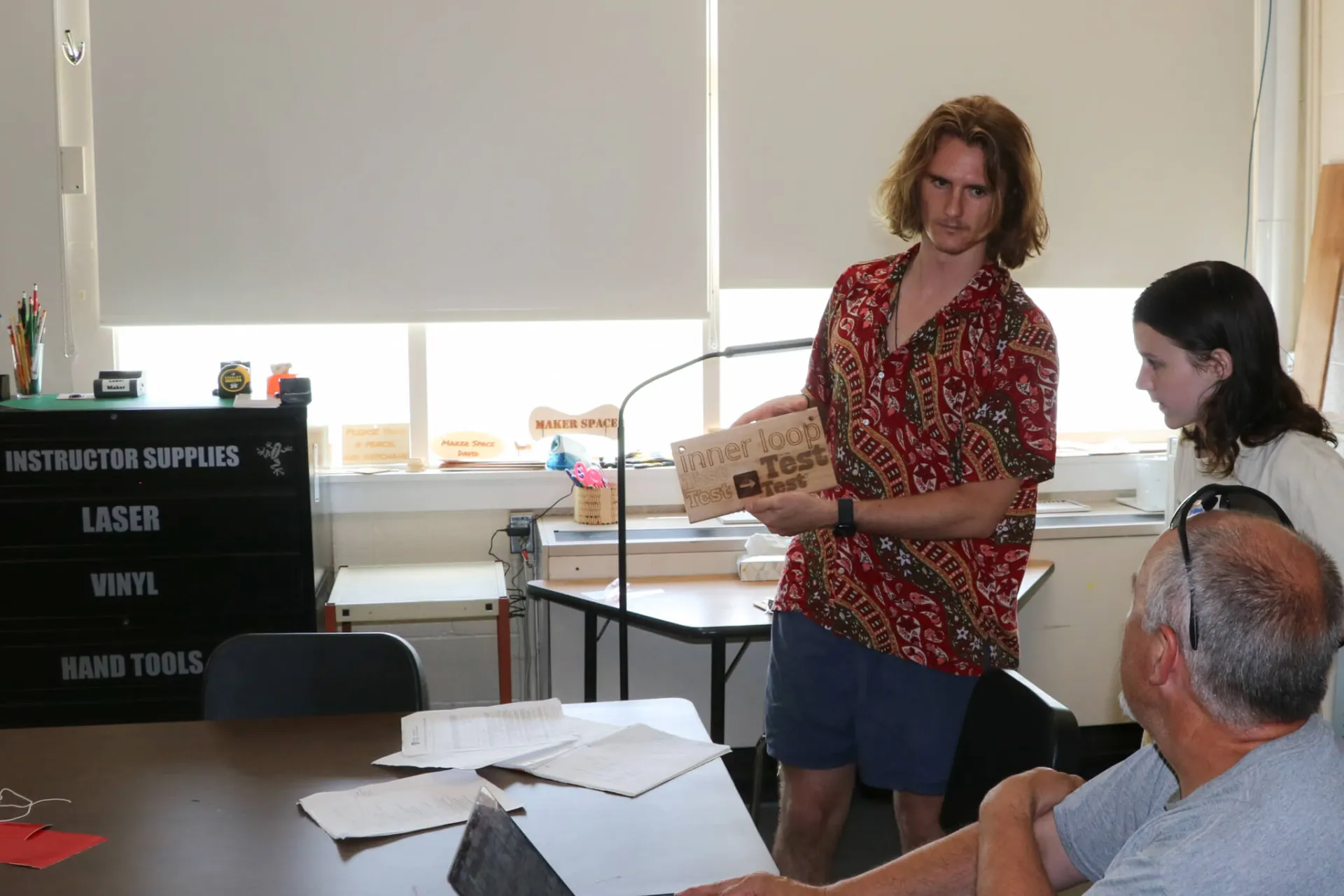 Robbie McKersie '25 shows off the custom fonts for Bethel's community trail network signs