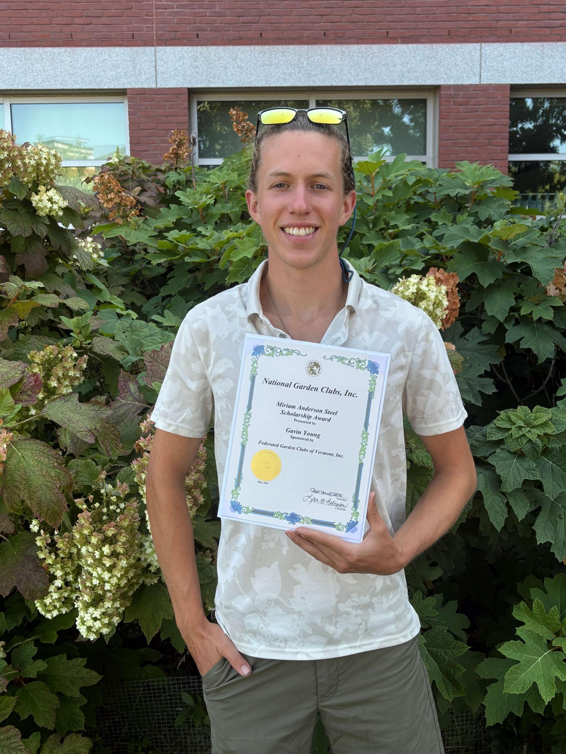 Gavin Young holding his award from the National Garden Clubs.