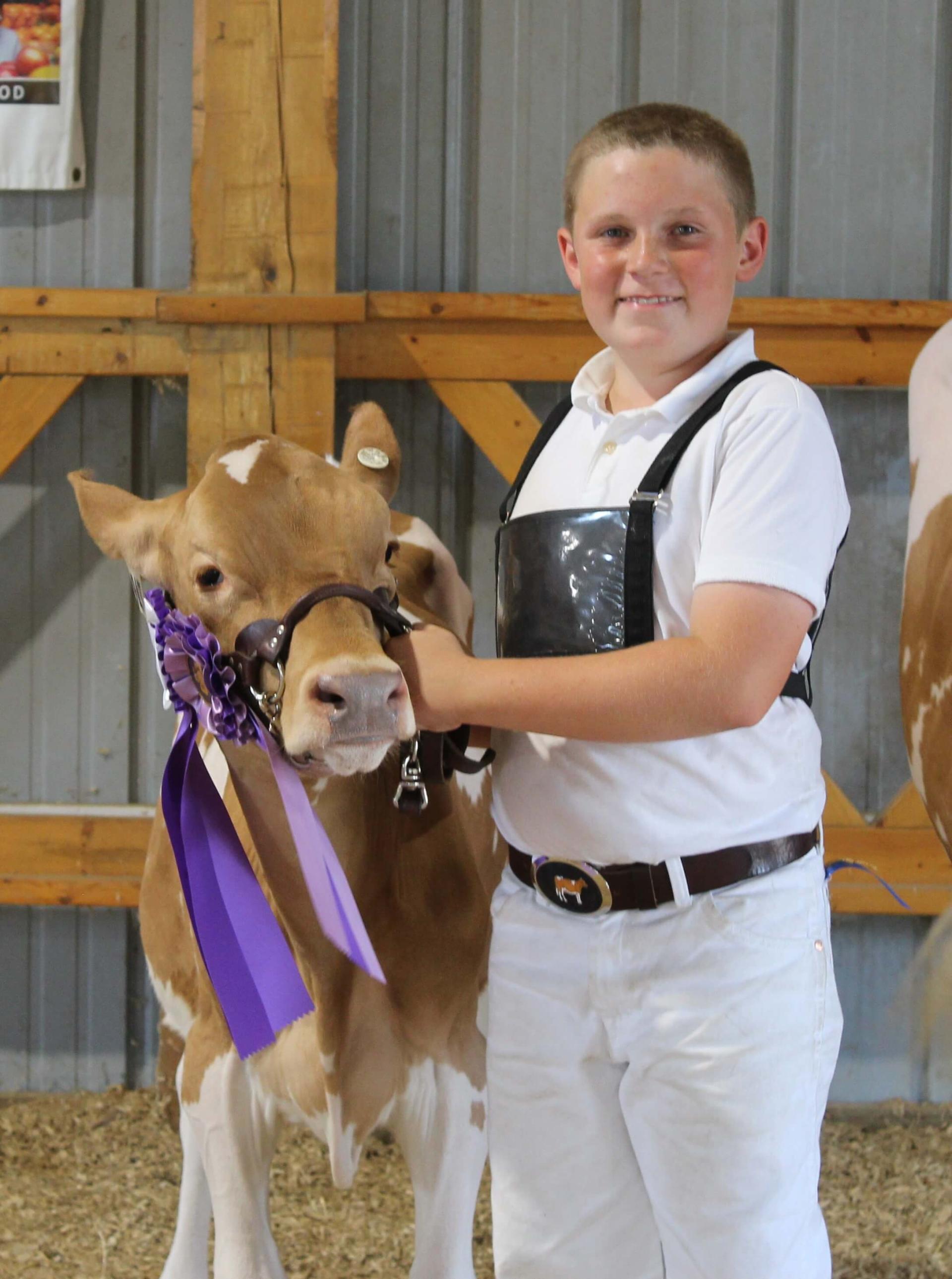 Boy with Calf and Grand Champion ribbon