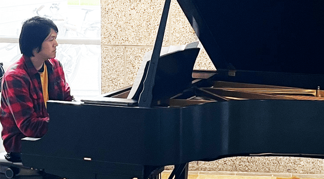 a person playing a grand piano