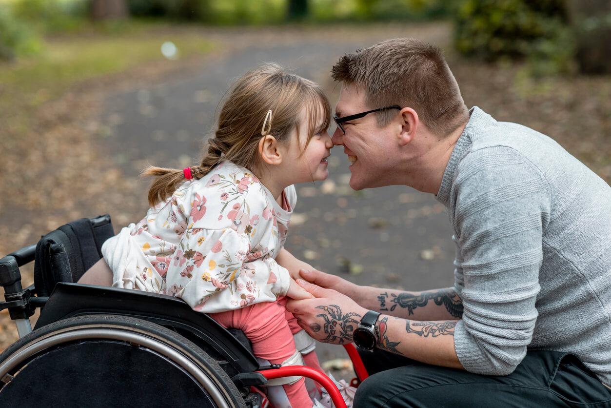 child in wheelchair with adult