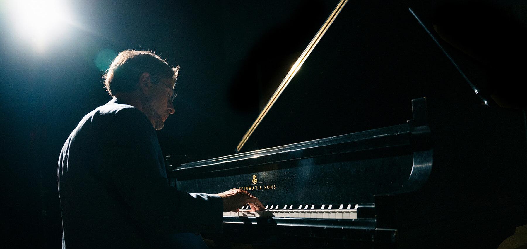 A person playing a piano on the stage