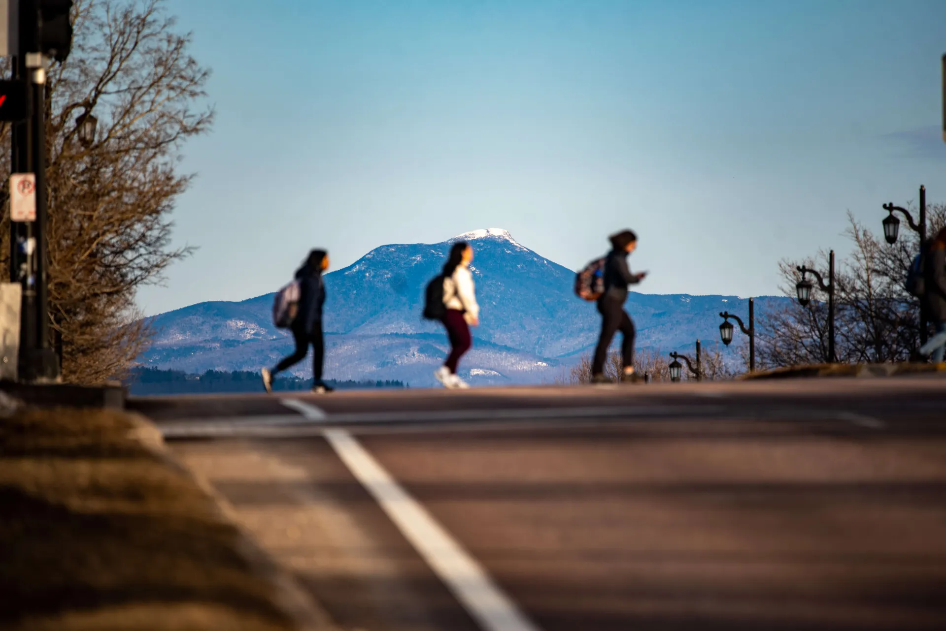 students crossing street with Camels Hump in background