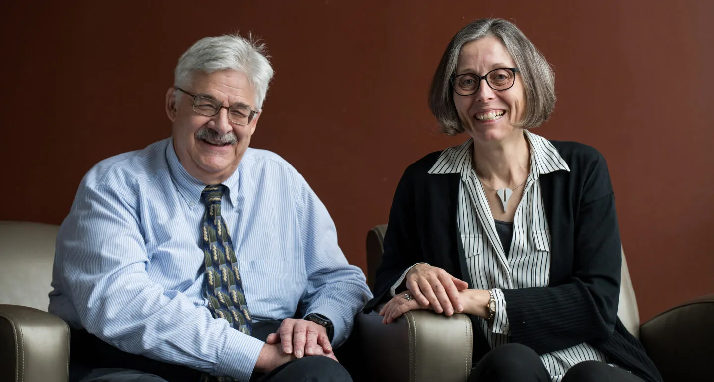 man and woman sitting together smiling
