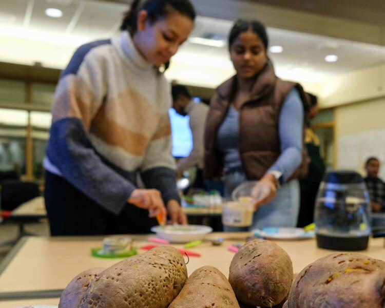 two people cooking with fresh produce
