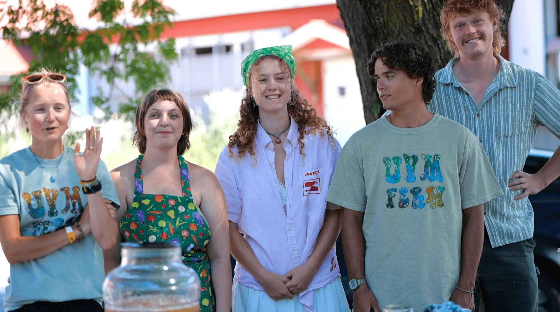 five students standing together smiling