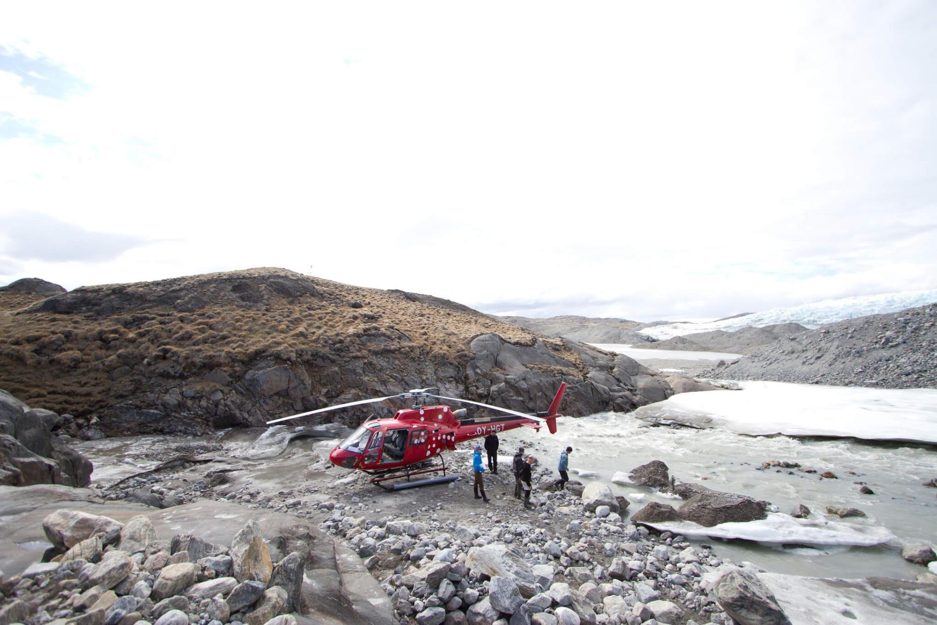 A red helicopter on rocky terrain