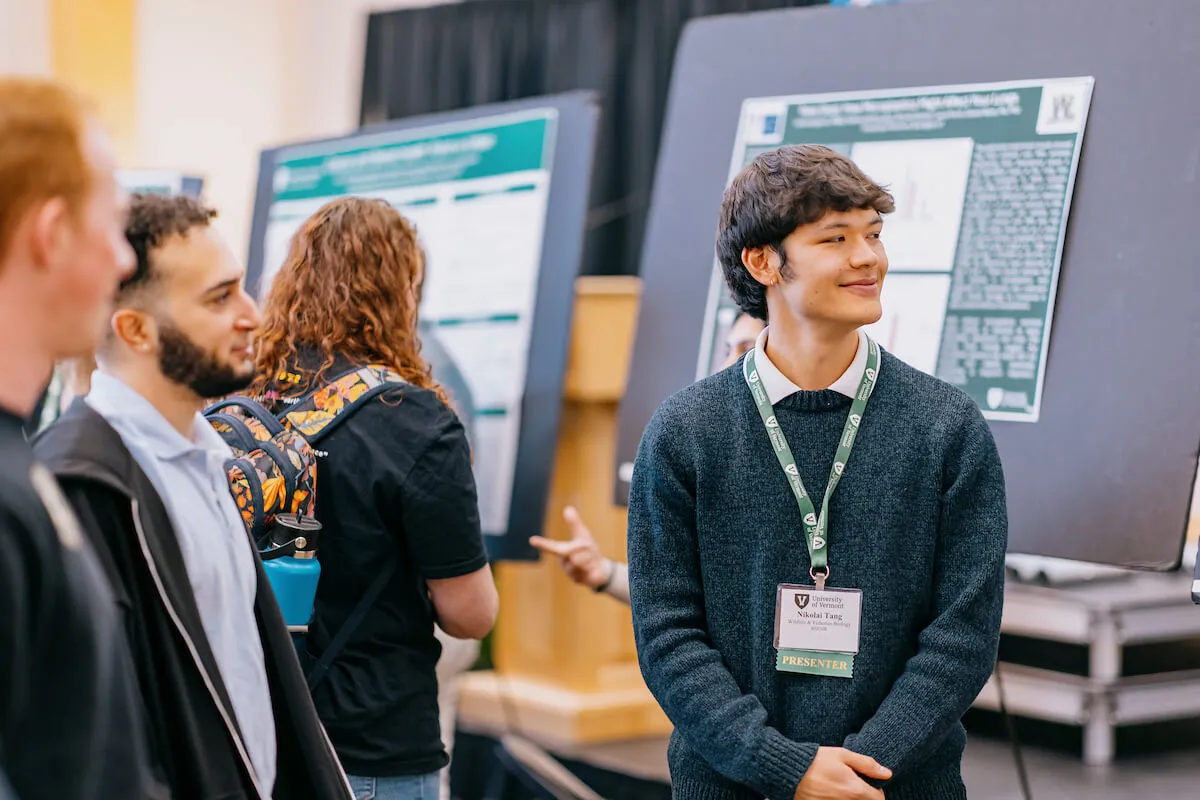 Students share poster presentations during a research conference